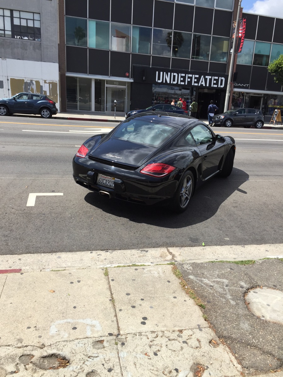 Porsche accross the street from Undefeated, a shoe store