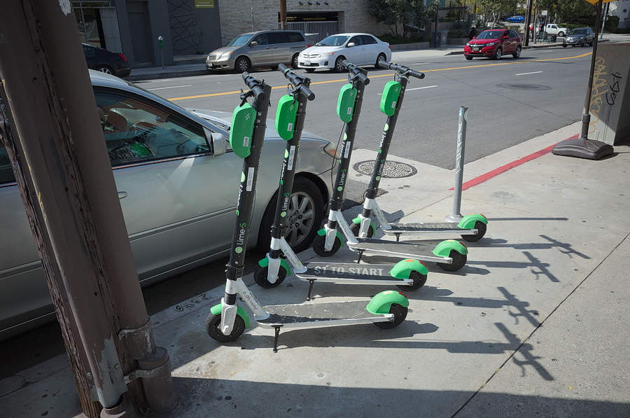 Four rental scooter in a line